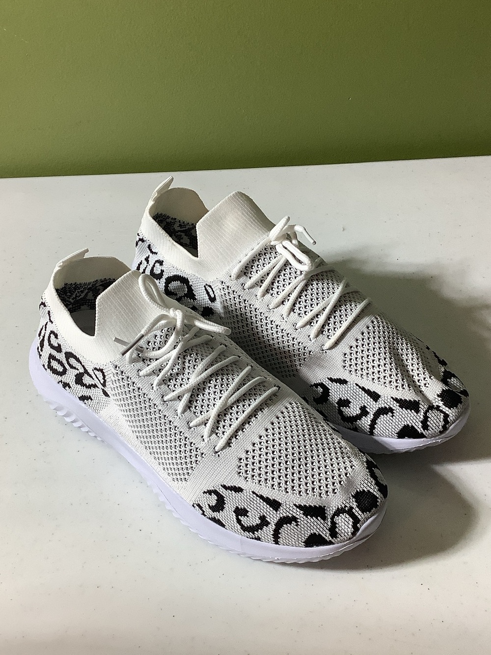 White leopard sock style pull on sneakers, size 11.5